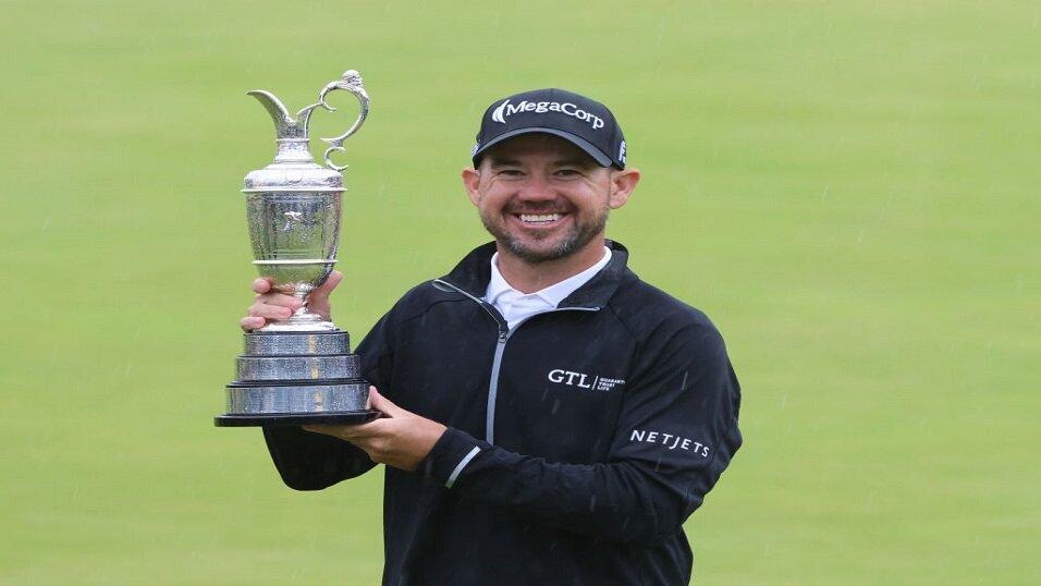 Brian Harman lifts the Claret Jug after winning the Open